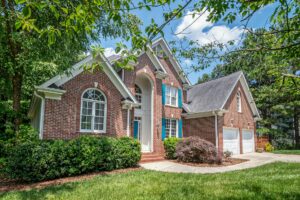 A mature shade tree anchoring the front yard of a Middletown NJ home in spring