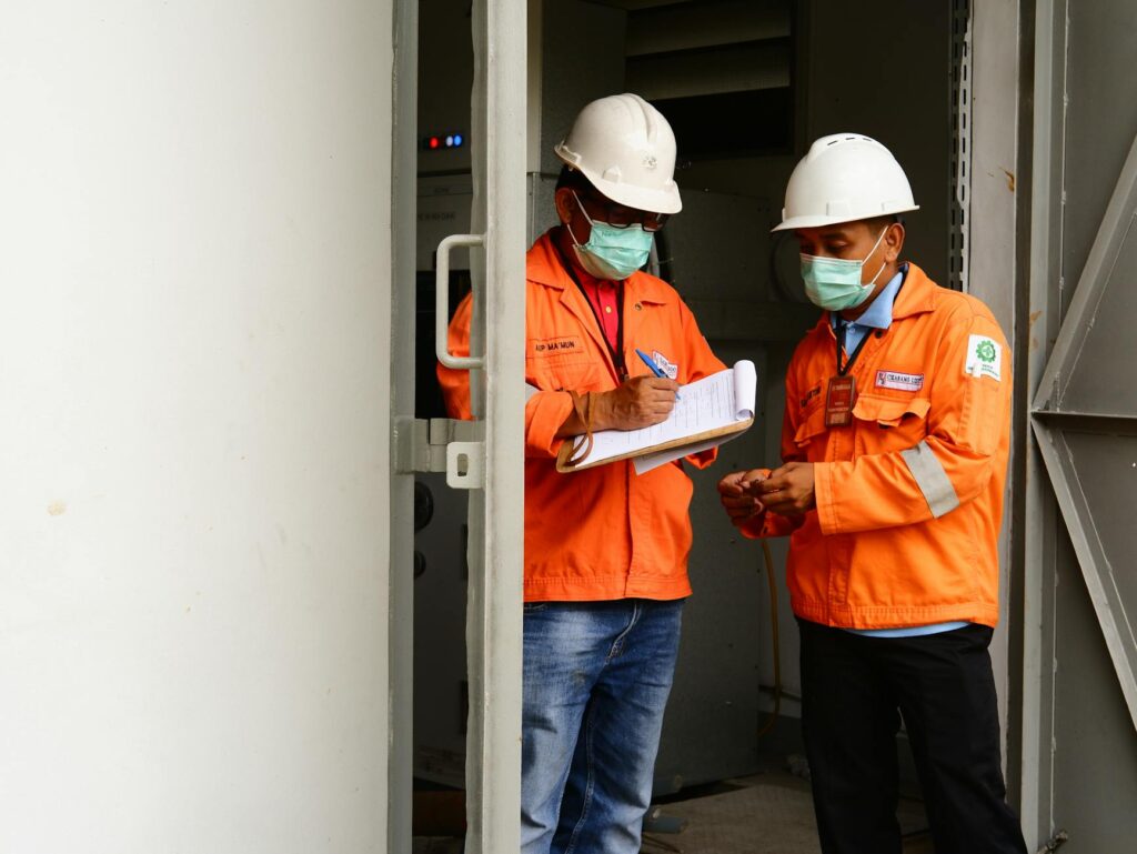 An arborist writes a professional tree inspection report on a clipboard