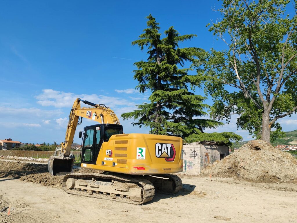 Construction equipment working near a large tree — excavation within the root zone can cause serious damage that appears in the crown years later