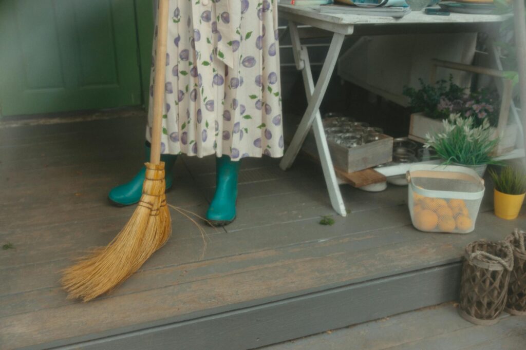 Homeowner cleaning garden tools and boots to prevent spread of invasive species