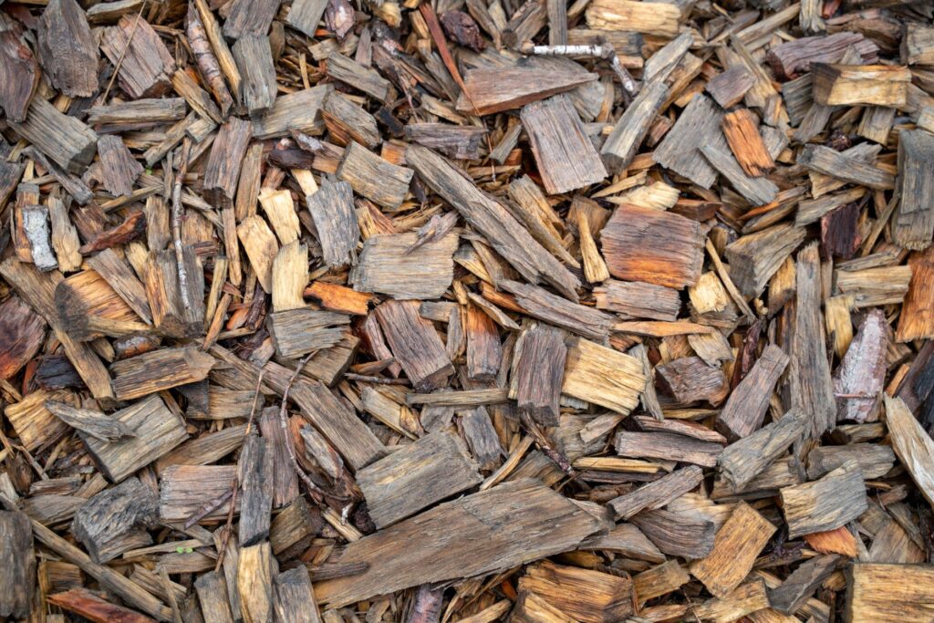 Pile of shredded hardwood bark mulch ready to be spread in a garden