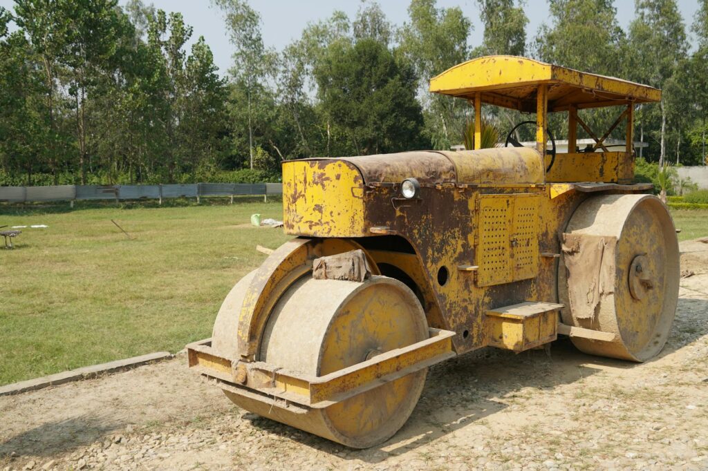 Heavy equipment causing soil compaction around the root zone of a mature shade tree