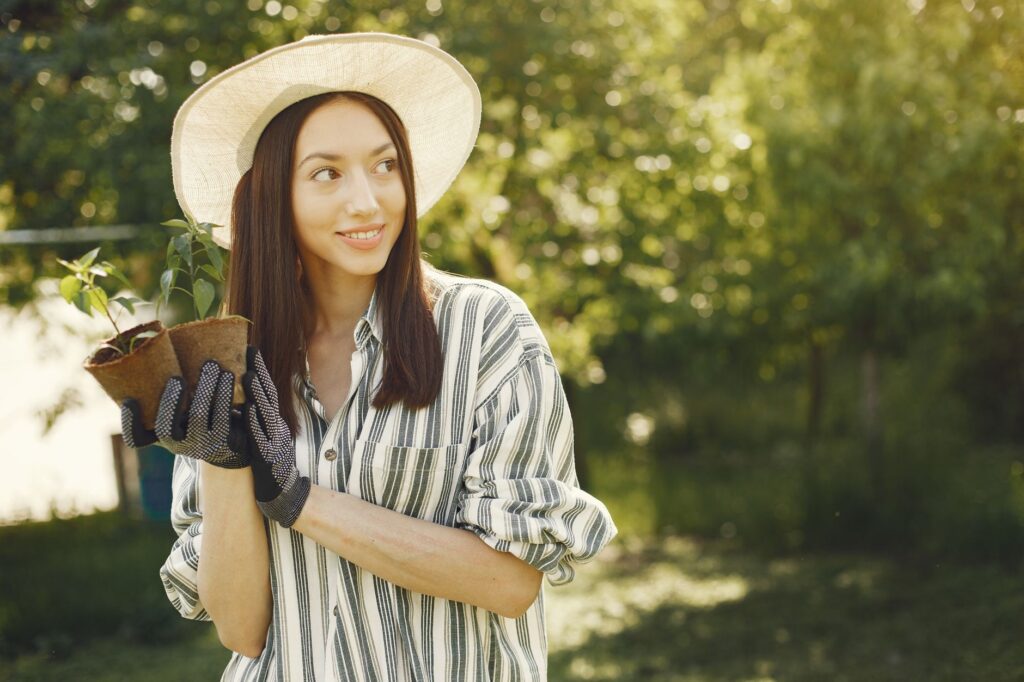 A homeowner evaluating a spot in the backyard for a newly planted tree