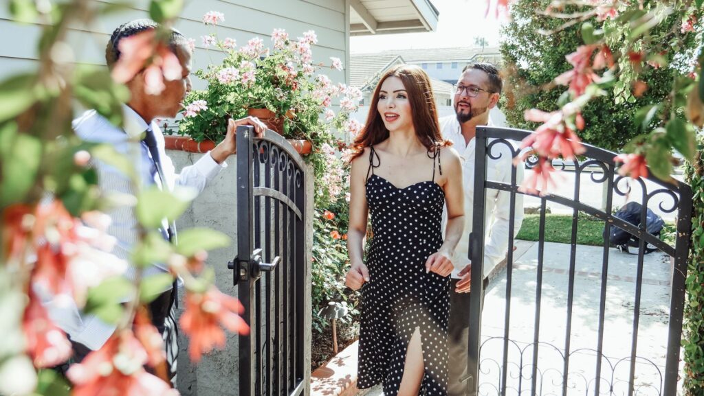 A real estate agent and homeowner walking a tree-lined Middletown property