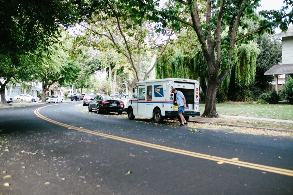 A shaded suburban Middletown street lined with mature oak trees on a summer afternoon