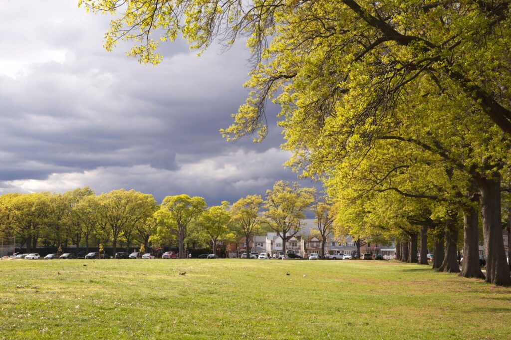 Dark storm clouds gathering over fully leafed shade trees near the New Jersey coast
