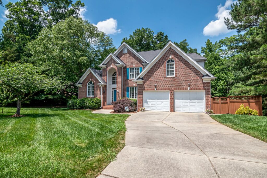 A healthy, well-maintained mature shade tree in front of a home ready for sale