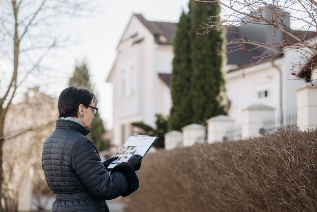 A certified arborist conducting a risk assessment of a mature tree