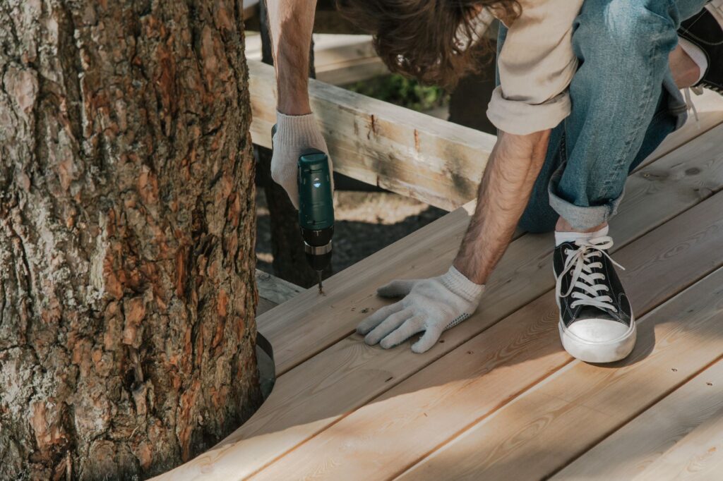 An arborist using a resistance drill to test a tree trunk for internal decay