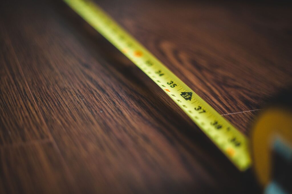 Measuring the planting distance between a young tree and a house foundation