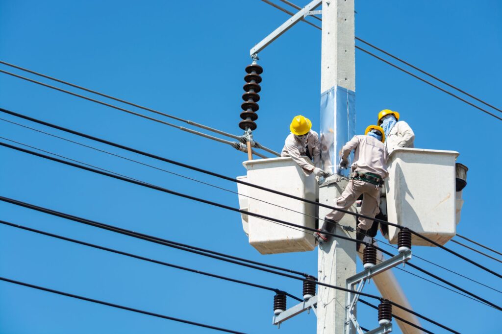 Line clearance arborist working from a bucket truck near power lines