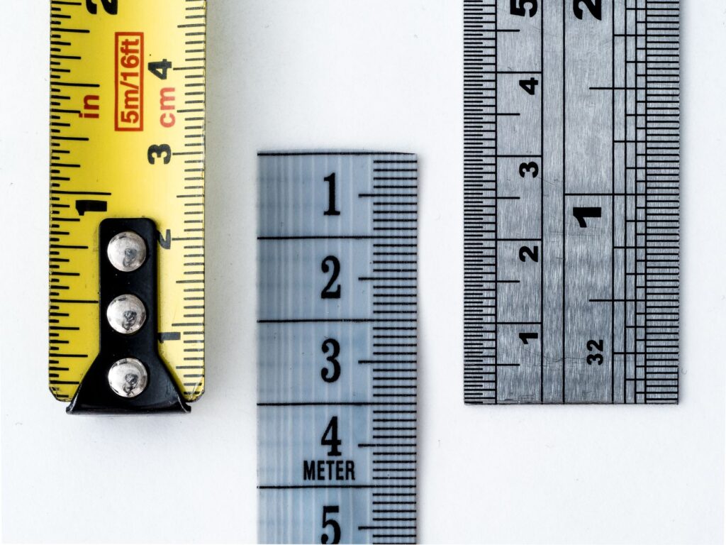 Measuring tape laid out on a lawn for planting layout