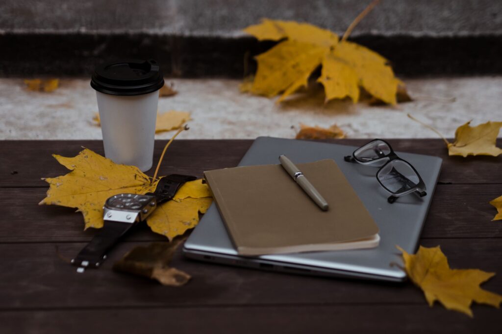Notebook and pen used to log tree observations in a backyard