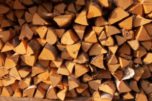 Split firewood stacked beside a fall backyard in Middletown